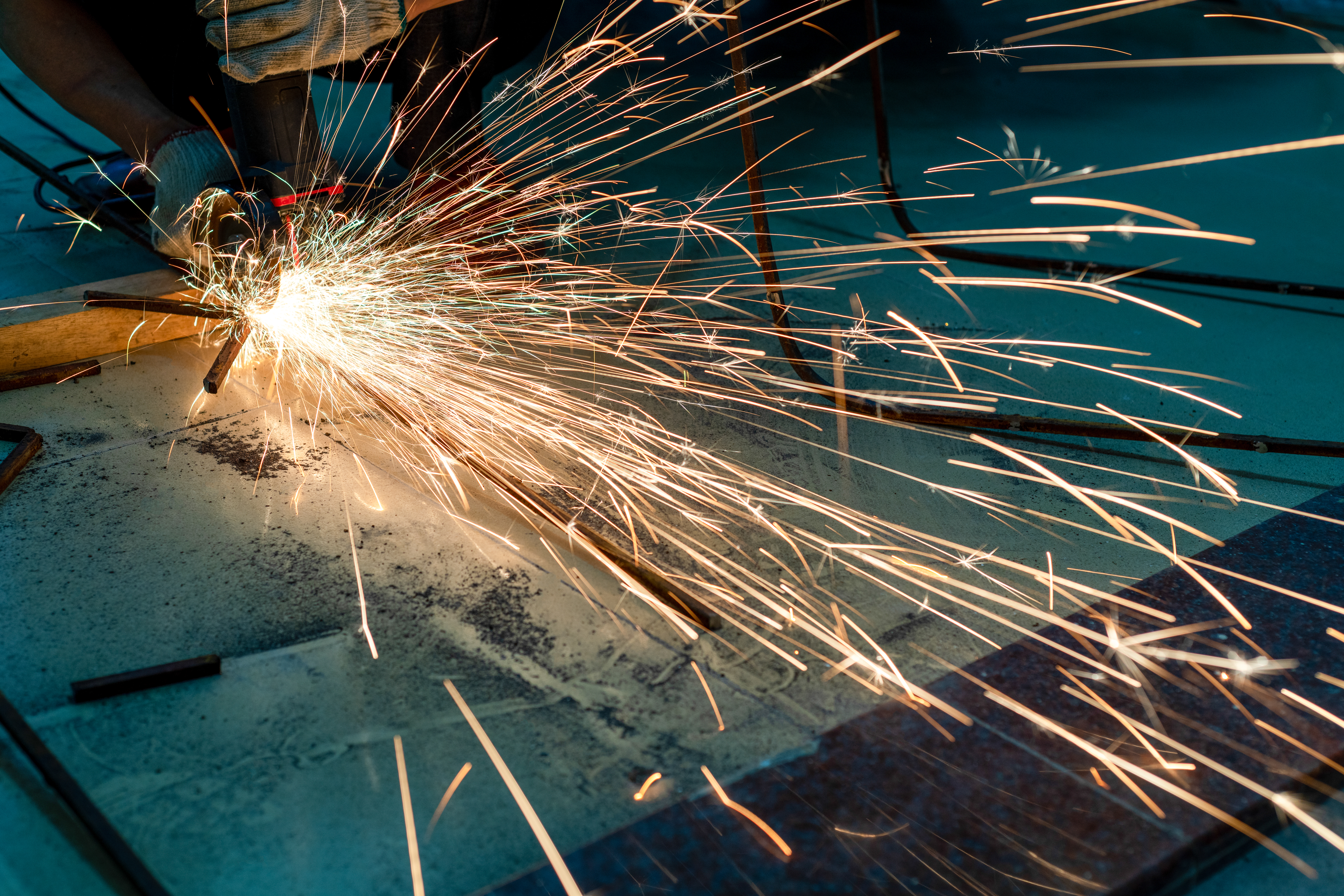 Metal cutting detail with sparks showing fabrication process and texture