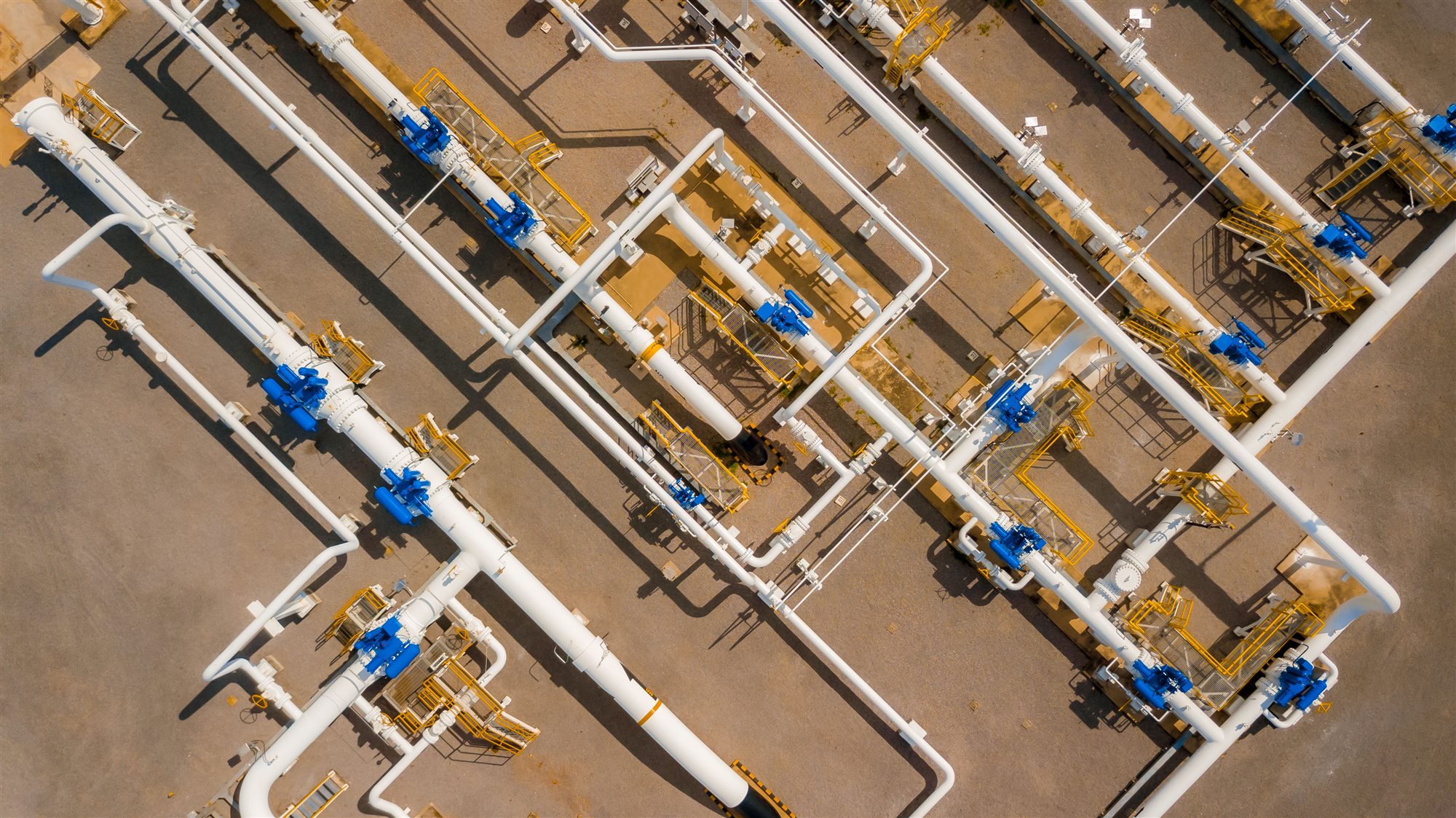Aerial view of a natural gas pipeline facility with valves and access platforms